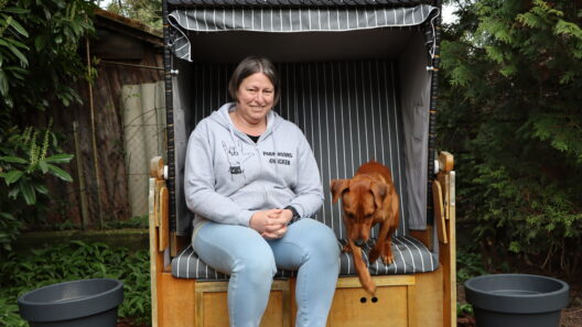 Silvia Lerch avec son chien, dans un fauteuil de plage de son jardin